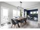 Dining room with modern lighting, a wooden table and backyard access at 6305 N Woodhaven Dr, McCordsville, IN 46055