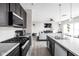 A modern kitchen with stainless steel appliances that transitions to the living room area at 6305 N Woodhaven Dr, McCordsville, IN 46055