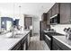 Modern kitchen with stainless steel appliances, a view into the living area at 6305 N Woodhaven Dr, McCordsville, IN 46055