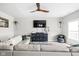 Spacious living room featuring a ceiling fan, hardwood floors, and a comfortable sectional sofa at 6305 N Woodhaven Dr, McCordsville, IN 46055