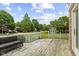 View from the wooden back deck showcases a well-manicured lawn and a charming storage shed in the backyard at 6518 Springview Dr, Avon, IN 46123