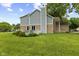 Picture of the back of the home featuring a well-manicured lawn, a brick and gray siding exterior, and a deck at 6518 Springview Dr, Avon, IN 46123