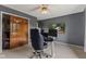 Inviting bedroom with a ceiling fan, workspace with monitors and view to media center for entertainment and productivity at 6518 Springview Dr, Avon, IN 46123