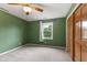 Bedroom with green walls, ceiling fan, window and closet at 6518 Springview Dr, Avon, IN 46123