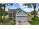 Charming home with a grey garage door, brick accents, and manicured landscaping at 6518 Springview Dr, Avon, IN 46123
