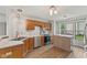 Well-lit kitchen with stainless steel appliances, wooden cabinets and flooring at 6518 Springview Dr, Avon, IN 46123