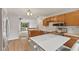 Well-lit kitchen with stainless steel appliances, wooden cabinets and island at 6518 Springview Dr, Avon, IN 46123