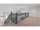 Carpeted loft area featuring a chandelier and railing overlooking the stairs at 6518 Springview Dr, Avon, IN 46123