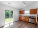Well-lit kitchen with wood cabinets, modern appliances, and a sliding glass door leading to the backyard at 6963 N Abilene Way, McCordsville, IN 46055