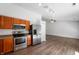 Functional kitchen equipped with stainless steel appliances, wood cabinets, and modern finishes at 6963 N Abilene Way, McCordsville, IN 46055