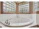 Luxurious bathtub with glass block windows that provide ample natural light at 6983 White Oak Dr, Avon, IN 46123