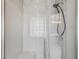 Modern shower stall featuring glass doors and neutral colored tile at 6983 White Oak Dr, Avon, IN 46123