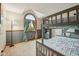 Cozy bedroom featuring a gray bunk bed, a unique arched window, and soft, neutral tones at 6983 White Oak Dr, Avon, IN 46123