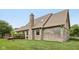 Exterior of a brick home featuring a brick chimney, and manicured lawn at 6983 White Oak Dr, Avon, IN 46123