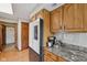 Kitchen featuring granite counters, stainless refrigerator and oak cabinets for a warm feel at 6983 White Oak Dr, Avon, IN 46123
