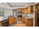 Galley kitchen featuring granite countertops, stainless appliances and oak cabinets for a warm feel at 6983 White Oak Dr, Avon, IN 46123