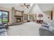 Open living room with a brick fireplace, skylight, and view into the dining area at 6983 White Oak Dr, Avon, IN 46123