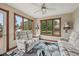 Cozy sunroom with large windows and comfortable floral print furniture at 6983 White Oak Dr, Avon, IN 46123