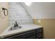 A sink and counter in the wet bar area with accent wallpaper at 6983 White Oak Dr, Avon, IN 46123