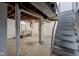 Partially finished basement with painted walls and exposed ceiling, including laundry hookups and stairs at 715 Kessler Blvd E Dr, Indianapolis, IN 46220