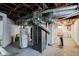 Unfinished basement showing water heater, furnace, plumbing, and laundry area at 715 Kessler Blvd E Dr, Indianapolis, IN 46220