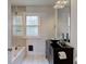 Modern bathroom with glass-enclosed tub, stylish vanity, and decorative lighting at 715 Kessler Blvd E Dr, Indianapolis, IN 46220