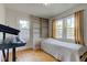Sunlit bedroom boasting hardwood floors, neutral walls, and built-in shelving at 715 Kessler Blvd E Dr, Indianapolis, IN 46220