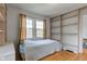 Bright bedroom featuring hardwood floors, neutral walls, and built-in shelving at 715 Kessler Blvd E Dr, Indianapolis, IN 46220