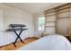 Bright bedroom featuring hardwood floors, neutral walls, and built-in shelving at 715 Kessler Blvd E Dr, Indianapolis, IN 46220