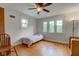 Bedroom featuring hardwood floors, a ceiling fan, and lots of natural light at 715 Kessler Blvd E Dr, Indianapolis, IN 46220