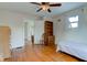 Cozy bedroom featuring hardwood floors, ceiling fan, and natural light from window at 715 Kessler Blvd E Dr, Indianapolis, IN 46220