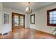 Elegant dining room with hardwood floors, built-in cabinet, and vintage-style French doors at 715 Kessler Blvd E Dr, Indianapolis, IN 46220