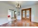Dining room with an archway to a living area, dark hardwood floors, and decorative doors to a sunroom at 715 Kessler Blvd E Dr, Indianapolis, IN 46220