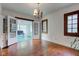 Bright dining room with hardwood floors, vintage lighting, and access to adjacent rooms through French doors at 715 Kessler Blvd E Dr, Indianapolis, IN 46220
