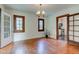 Charming dining room featuring hardwood floors, wood-framed windows, and a vintage chandelier at 715 Kessler Blvd E Dr, Indianapolis, IN 46220