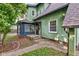 Charming home exterior featuring a sunroom, complemented by a quaint walkway and well-manicured landscaping at 715 Kessler Blvd E Dr, Indianapolis, IN 46220