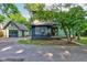 Charming home featuring green siding, blue accents, and a detached garage at 715 Kessler Blvd E Dr, Indianapolis, IN 46220