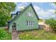 Unique green home features a distinct, charming architectural design and well-kept lawn at 715 Kessler Blvd E Dr, Indianapolis, IN 46220