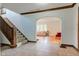 Spacious foyer with a staircase and archway, leading to a bright living area with hardwood floors at 715 Kessler Blvd E Dr, Indianapolis, IN 46220