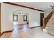 Open foyer featuring archway, staircase with carpet runner, and hardwood flooring leading to dining space at 715 Kessler Blvd E Dr, Indianapolis, IN 46220