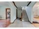Bright foyer with staircase and archways lead to the living room and kitchen spaces at 715 Kessler Blvd E Dr, Indianapolis, IN 46220