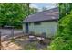 Detached garage with exterior seating, set in a partially shaded, private backyard space at 715 Kessler Blvd E Dr, Indianapolis, IN 46220