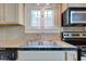 Close-up highlighting the kitchen sink and countertop area, featuring stainless steel appliances at 715 Kessler Blvd E Dr, Indianapolis, IN 46220