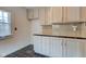 Kitchen featuring white cabinets and black tile countertops, providing a clean and classic look at 715 Kessler Blvd E Dr, Indianapolis, IN 46220