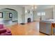 Spacious living room boasting a fireplace, hardwood floors, and an open archway to other rooms at 715 Kessler Blvd E Dr, Indianapolis, IN 46220