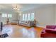 Bright living room featuring hardwood floors, neutral walls, and ample natural light through multiple windows at 715 Kessler Blvd E Dr, Indianapolis, IN 46220