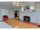Inviting living room with a painted fireplace, hardwood floors, and natural light from large windows at 715 Kessler Blvd E Dr, Indianapolis, IN 46220