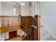 Staircase featuring beautiful wood railing, carpeted steps, and access to a lower level at 715 Kessler Blvd E Dr, Indianapolis, IN 46220