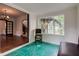 Sunroom features large window and archway, offering a bright and inviting space at 715 Kessler Blvd E Dr, Indianapolis, IN 46220
