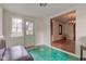 Bright sunroom with original tile floors and convenient access to both the exterior and the main living area at 715 Kessler Blvd E Dr, Indianapolis, IN 46220